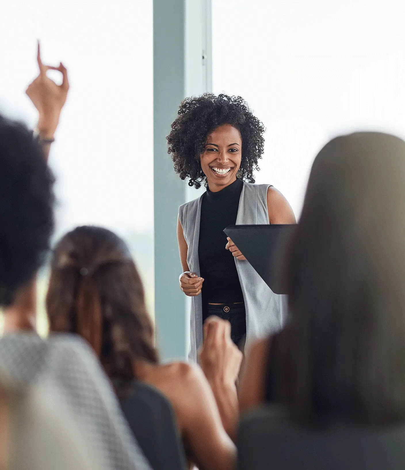Frau h&auml;lt einen Vortrag und ein Zuschauer zeigt auf
